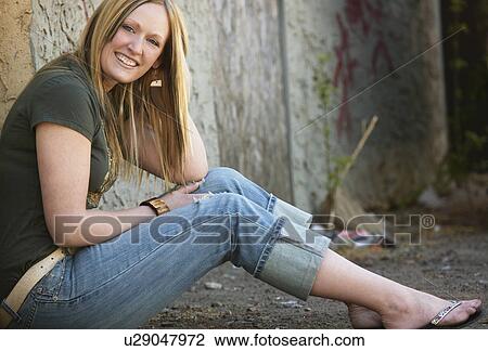 Stock Image - Woman in alley. Fotosearch