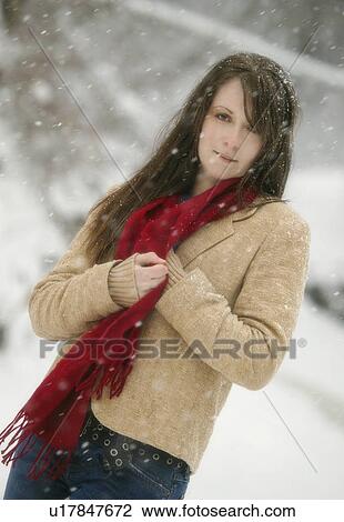 Woman standing while snow is falling View Large Photo Image Stock Image - Woman standing while snow is falling. Fotosearch