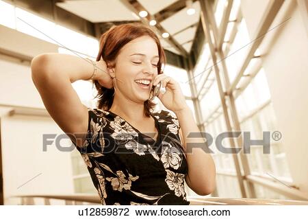 Stock Image - Woman talks on the phone. Fotosearch