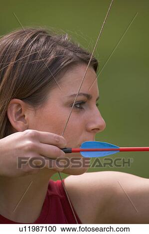 Woman with bow and arrow View Large Photo Image Stock Image - Woman with bow and arrow. Fotosearch
