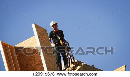 Stock Photo - Worker on roof. Fotosearch
