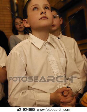 Stock Image - Young boy praying. Fotosearch