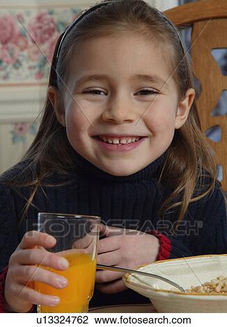 Young girl with food at breakfast table View Large Photo Image Stock Image - Young girl with food at breakfast table. Fotosearch