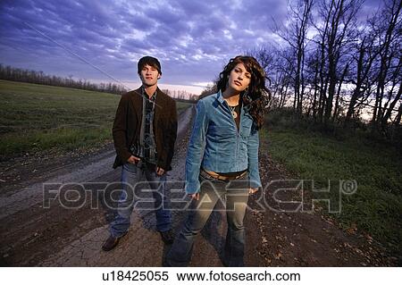 Stock Photography - Young trendy man and woman outside. Fotosearch