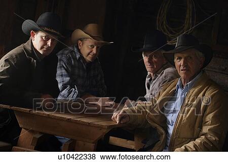 Stock Photo - A group of cowboys. Fotosearch