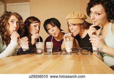 Stock Image - A group of girls drinking milkshakes. Fotosearch