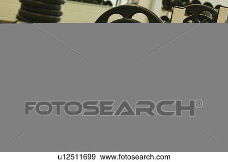 Stock Photo - A man lifting weights. Fotosearch
