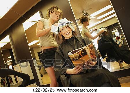 A young woman having her hair highlighted View Large Photo Image Stock Photography - A young woman having her hair highlighted. Fotosearch