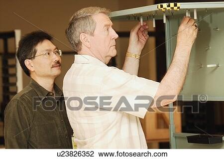 An occupational therapist working with a senior businessman View Large Photo Image Stock Image - An occupational therapist working with a senior businessman. Fotosearch
