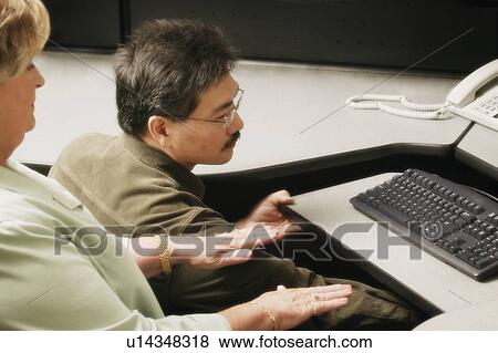 An occupational therapist working with a businesswoman View Large Photo Image Stock Photo - An occupational therapist working with a businesswoman. Fotosearch