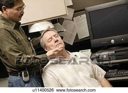 An occupational therapist working with a senior businessman View Large Photo Image Stock Photograph - An occupational therapist working with a senior businessman. Fotosearch