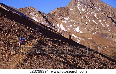 Picture - Backpackers traversing Cataract Pass at White Goat Wilderness Area. Fotosearch