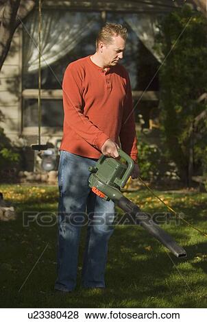 Blowing leaves out of the yard View Large Photo Image Stock Photo - Blowing leaves out of the yard. Fotosearch