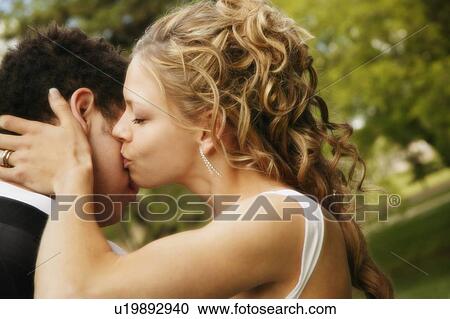 Bride and groom kisses groom View Large Photo Image Stock Image - Bride and groom kisses groom. Fotosearch