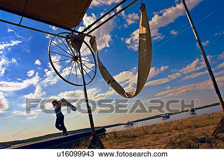Stock Image - Child plays down by the beach. Fotosearch