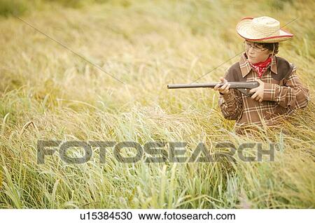 Stock Image - Child pretending to hunt. Fotosearch
