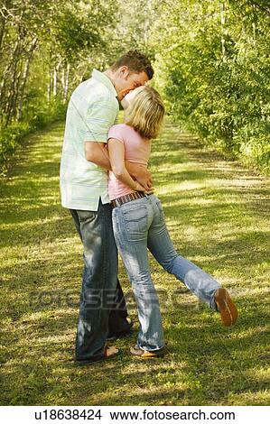 Picture - Couple stop to kiss. Fotosearch