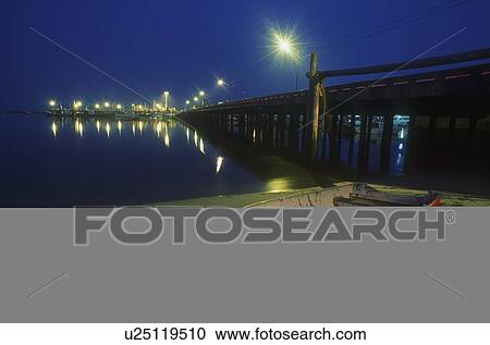 Stock Image - Empty rowboat at night, Provincetown, Cape Cod, Massachusetts, U. S. A.. Fotosearch