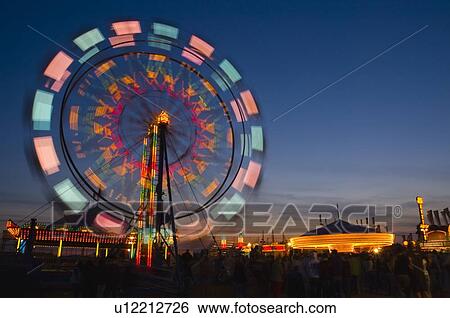 Ferris wheel in the evening View Large Photo Image Stock Photograph - Ferris wheel in the evening. Fotosearch