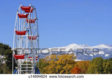 Picture - Ferris wheel overlooking mountains. Fotosearch