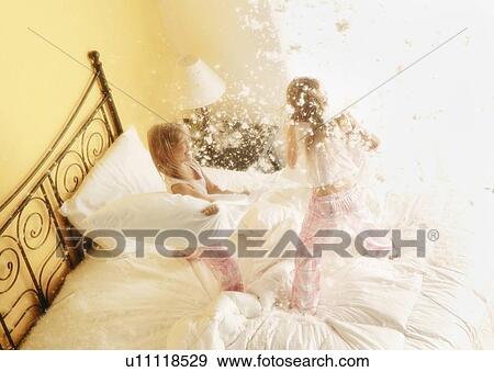 Girls having pillow fight View Large Photo Image Stock Photo - Girls having pillow fight. Fotosearch