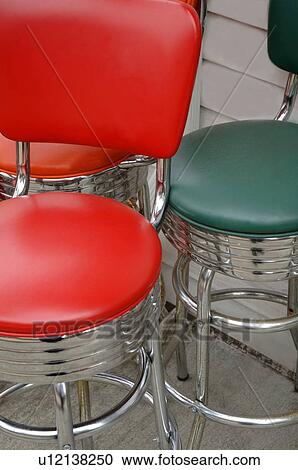 Stock Image - Green and red bar stools. Fotosearch