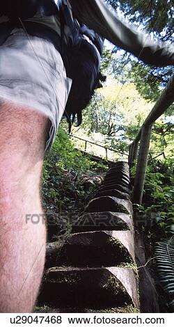 Stock Photo - Hiker walking down a staircase. Fotosearch
