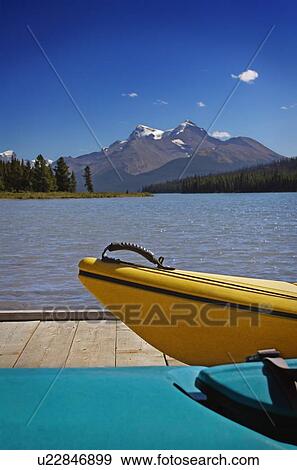 Kayaks waiting on a dock View Large Photo Image Stock Photo - Kayaks waiting on a dock. Fotosearch