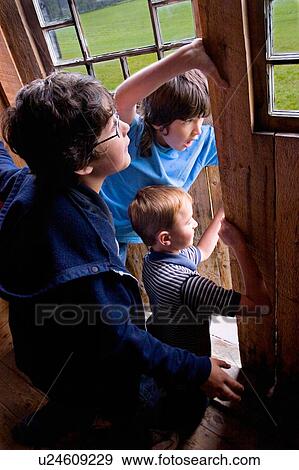 Stock Photo - Kids peek out door. Fotosearch