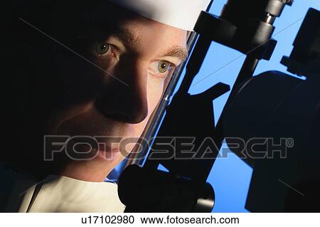 Stock Image - Man having an eye exam. Fotosearch