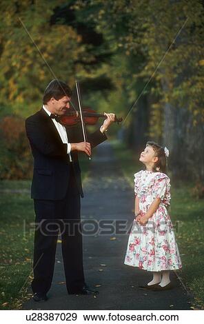 Man plays violin for child View Large Photo Image Stock Photo - Man plays violin for child. Fotosearch