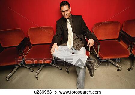 Stock Photography - Man sitting in waiting room. Fotosearch