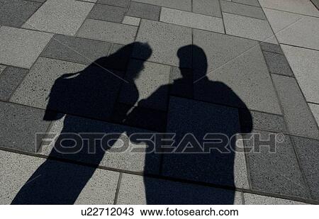 Shadow of two people standing View Large Photo Image Stock Image - Shadow of two people standing. Fotosearch