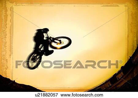 Silhouette of stunt cyclist View Large Photo Image Stock Photo - Silhouette of stunt cyclist. Fotosearch