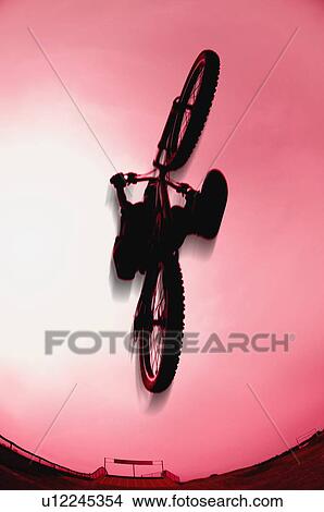 Silhouette stunt bike rider View Large Photo Image Picture - Silhouette stunt bike rider. Fotosearch