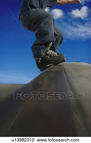 Stock Image - Skating down a ramp. Fotosearch