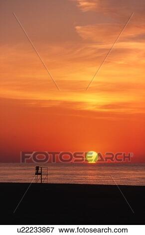 Stock Photo - Sunrise over the beach in Toronto. Fotosearch