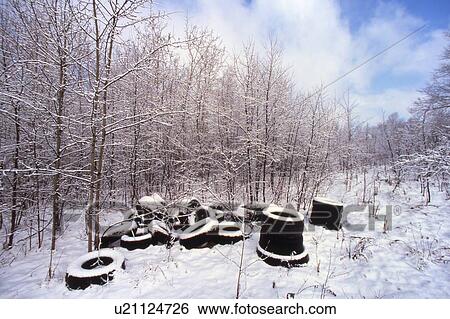 Stock Photograph - Tires thrown in isolated area. Fotosearch