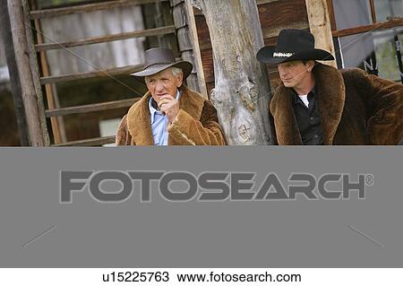 Stock Image - Two cowboys on a ranch. Fotosearch