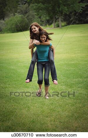 Stock Image - Two friends in the park. Fotosearch