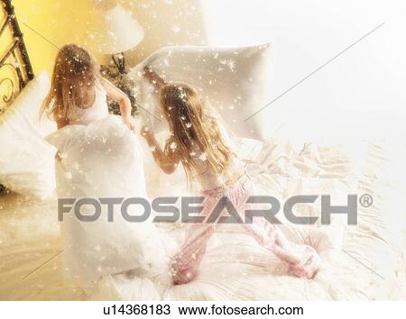 Two girls having pillow fight View Large Photo Image Stock Image - Two girls having pillow fight. Fotosearch