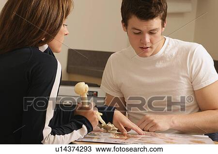 Stock Image - Two people discussing anatomy. Fotosearch