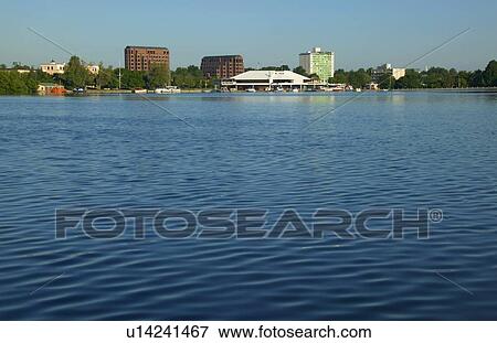 View of a city across a lake View Large Photo Image Stock Photo - View of a city across a lake. Fotosearch
