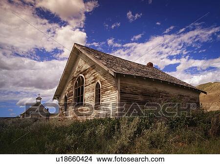 Picture - Weathered wooden building and church. Fotosearch