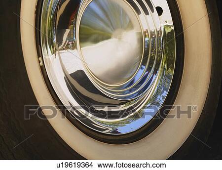 Picture - White-walled tire and chrome hub cap. Fotosearch