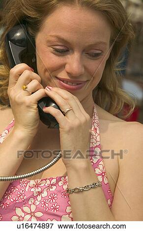 Stock Photo - Woman listening on the phone. Fotosearch