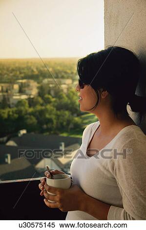 Woman looks out the window View Large Photo Image Stock Photography - Woman looks out the window. Fotosearch