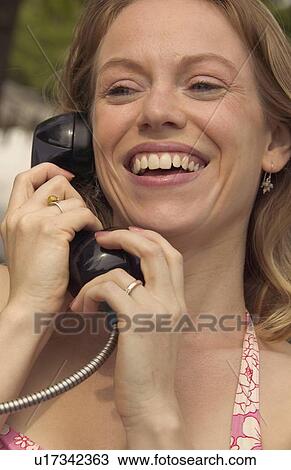 Woman on the phone laughing View Large Photo Image Stock Image - Woman on the phone laughing. Fotosearch