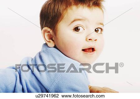 A baby looks over shoulder View Large Photo Image Stock Image - A baby looks over shoulder. Fotosearch