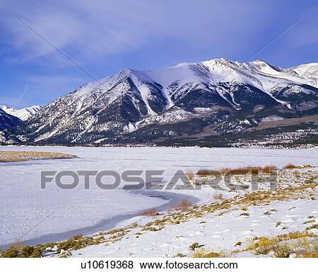Stock Photo - A frozen lake in the Rocky Mountains. Fotosearch
